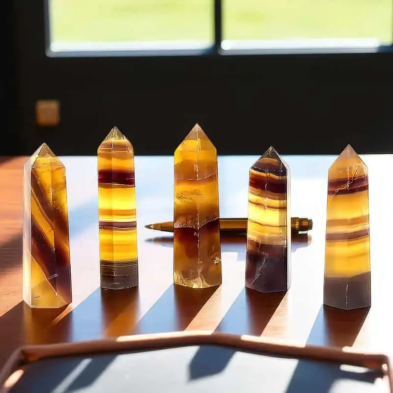 Discover the Allure of Brown Fluorite Towers Our set of five hand‑picked 3-inch and 4-inch brown fluorite towers showcases nature’s own palette—deep, earthy browns interwoven with subtle crystal hues that shift with every angle. Elegant Distinction Each tower is a sculptural statement: the robust brown base anchors your décor, while crystalline bands ripple across its surface, creating a dynamic interplay of light and shadow. The result? A focal point that’s both refined and unmistakably original. Naturally Accented Form Fluorite’s characteristic banding brings a decorative display of natural art, whether you adorn a bookshelf or place them as a centerpiece on a coffee table. A Touch of Extraordinary So unique, no two towers are identical. The gentle variations in hue and pattern make the collection an elegant home decor centerpiece.