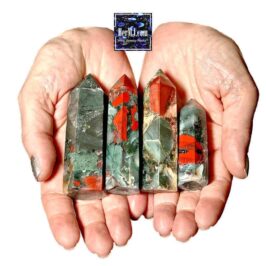 HerMJ - Bloodstone Tower Crystals - Held In Hands. Vibrant gemstone healing crystals with green, red, and black hues held in a person's hands, showcasing natural gemstone decor for wellness and spiritual growth.