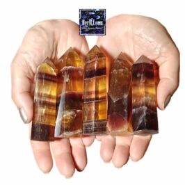 HerMJ - Brown Fluorite Towers - Held In Hands with rich golden, brown, and reddish hues, showcasing natural banding and polished facets from HerMJ Gemstone Decor collection.