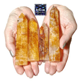 Golden Healer Tower Crystals gemstone jewelry display featuring handcrafted pieces with vibrant orange crystals and natural textures.
