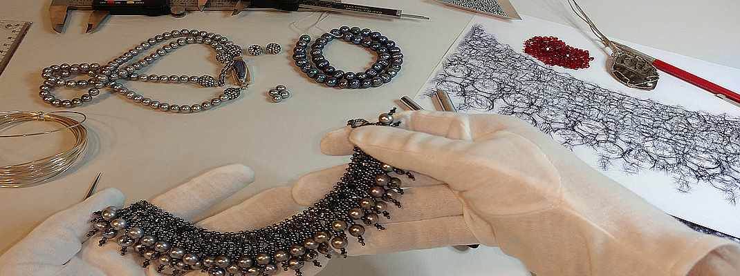 How to Appreciate Artisan Jewelry Craftsmanship Details An artisan works with Pearl and Gemstone Jewelry based on a sketch
