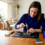 Jewelry maker hand stamping pendant at home