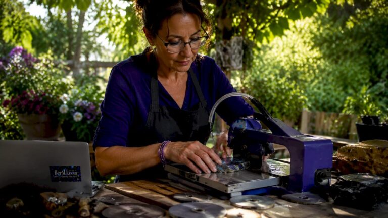 Artisan cutting raw gemstone slab