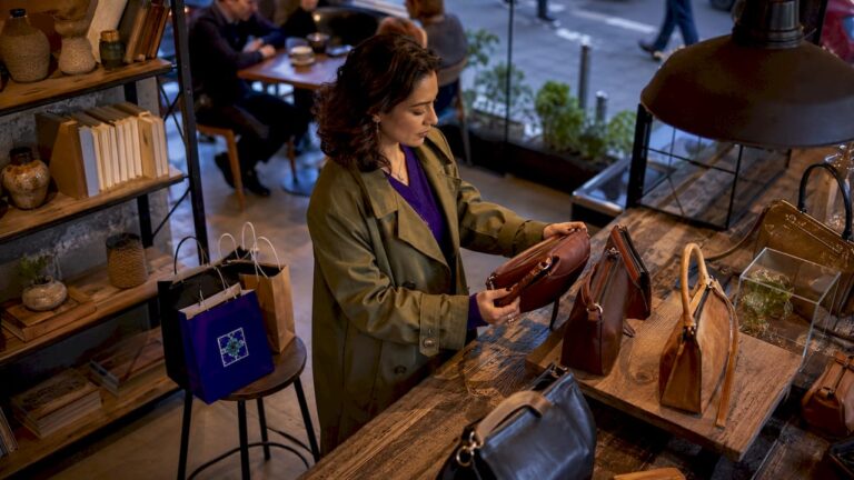 Woman shopping for luxury handbags in boutique