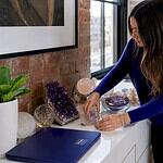 Woman arranging crystal decor in living room