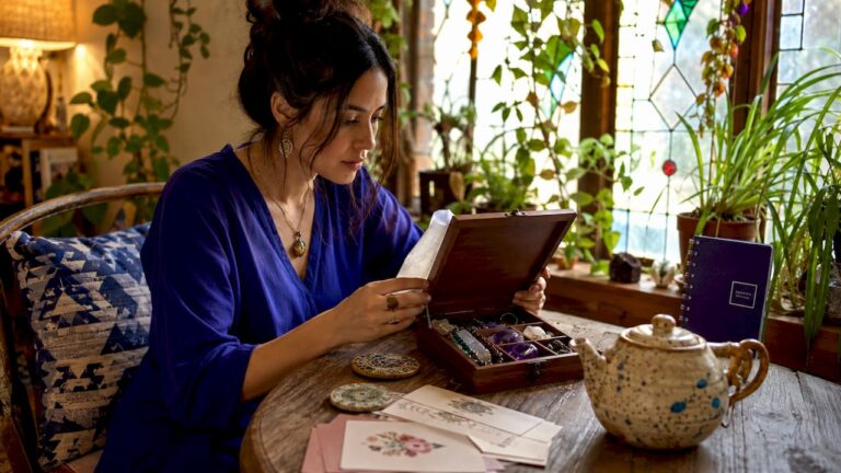 Woman examining gemstone jewelry gift in living room