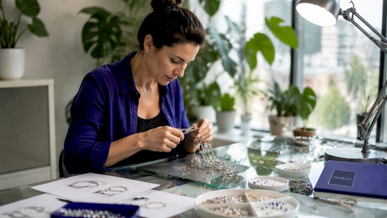 Artisan shaping wearable art jewelry in studio