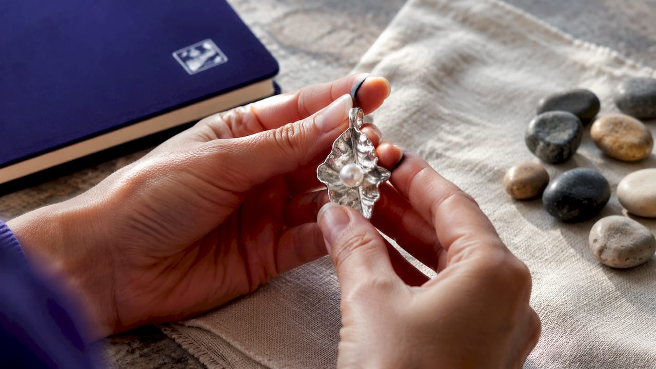 What Is Organic Jewelry Design? A Modern Style Guide Close-up of asymmetrical organic jewelry pendant with pearl