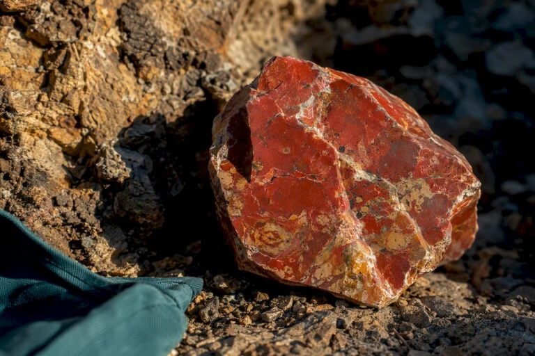 Patterned raw jasper beside weathered rock
