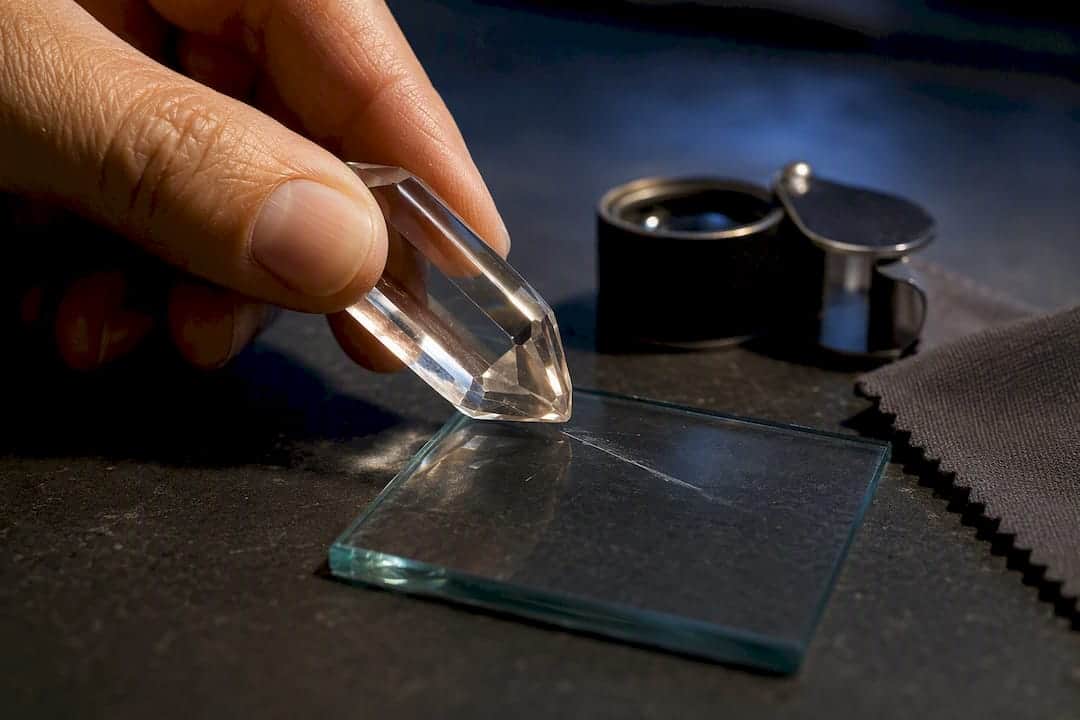 Quartz Scratches Glass (Mohs 7 vs 5.5): 4 Tests Jewelry Buyers Need Quartz crystal scratching a glass sample