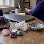 Desk crystals arranged beside a laptop