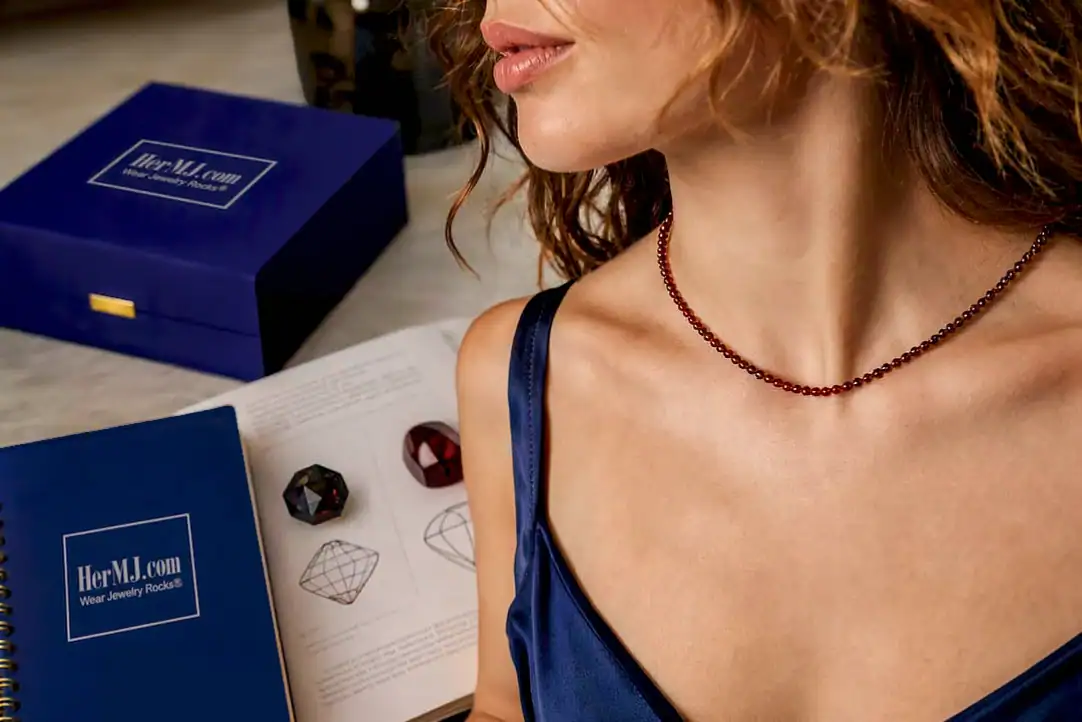 GIA Optics: 4 Questions to Choose Cabochon or Faceted Woman wearing an HerMJ garnet necklace